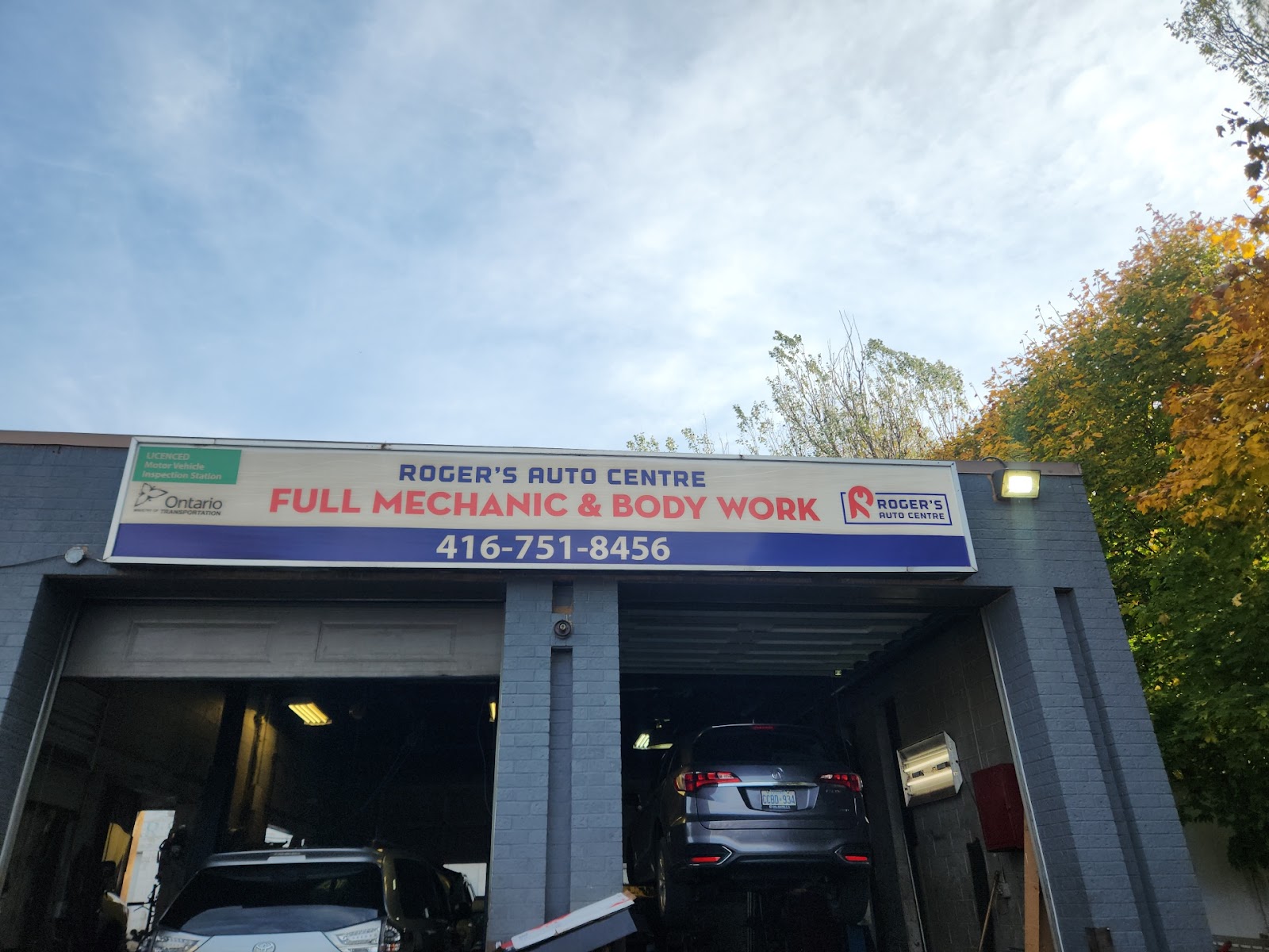 Front signage reading Roger&rsquo;s Auto Centre — Full Mechanic & Body Work — 416 751 8456, with the Ontario licensed inspection station decal.